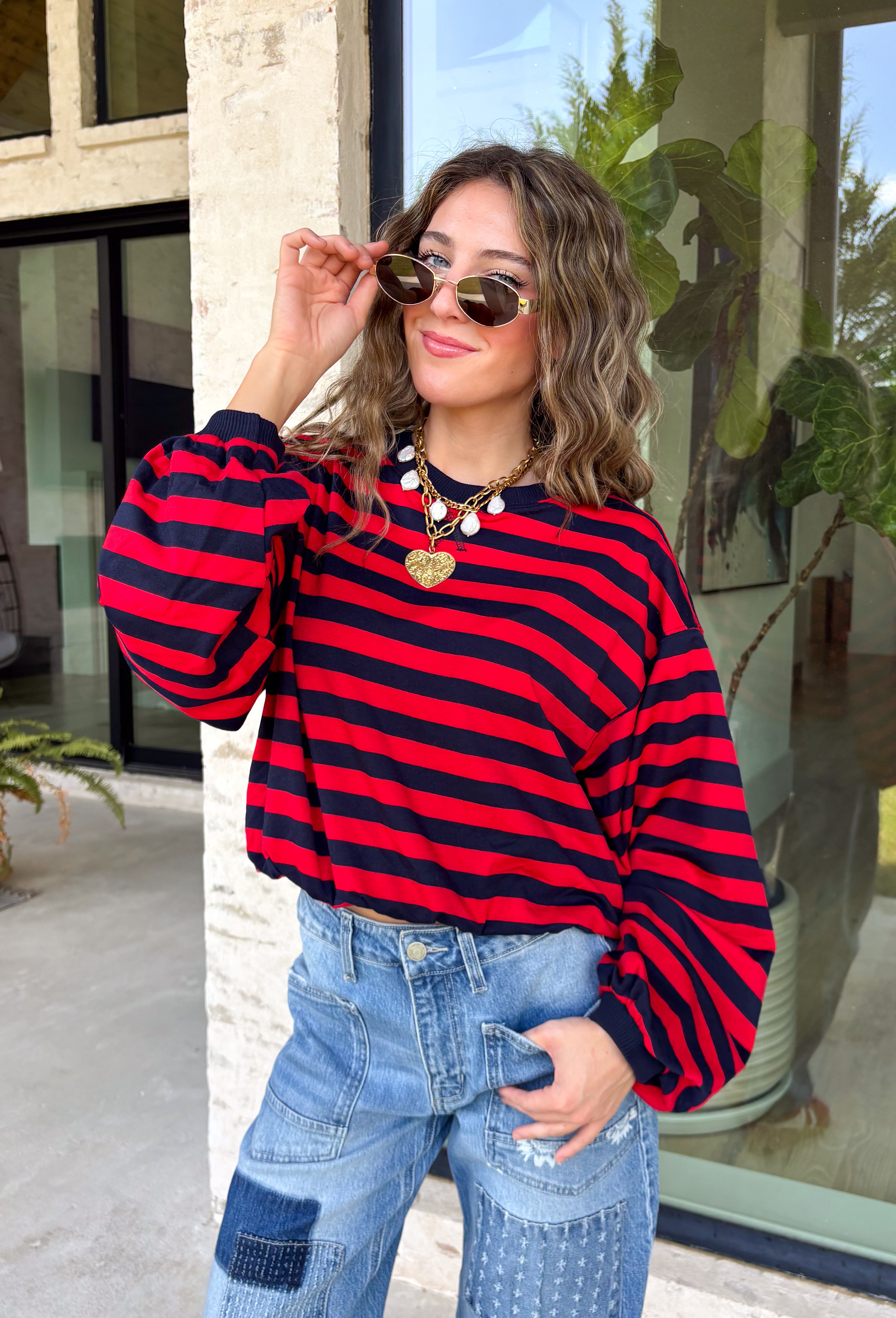 Classic stripes never go out of style, and this cozy knit top from Hyfve is the perfect addition to your fall wardrobe. Featuring bold red and navy stripes, this timeless top offers a relaxed silhouette that's easy to dress up or down. Ribbed detailing at the neckline, cuffs, and hem gives it a polished finish, while the soft fabric keeps you warm and comfortable all day long. 