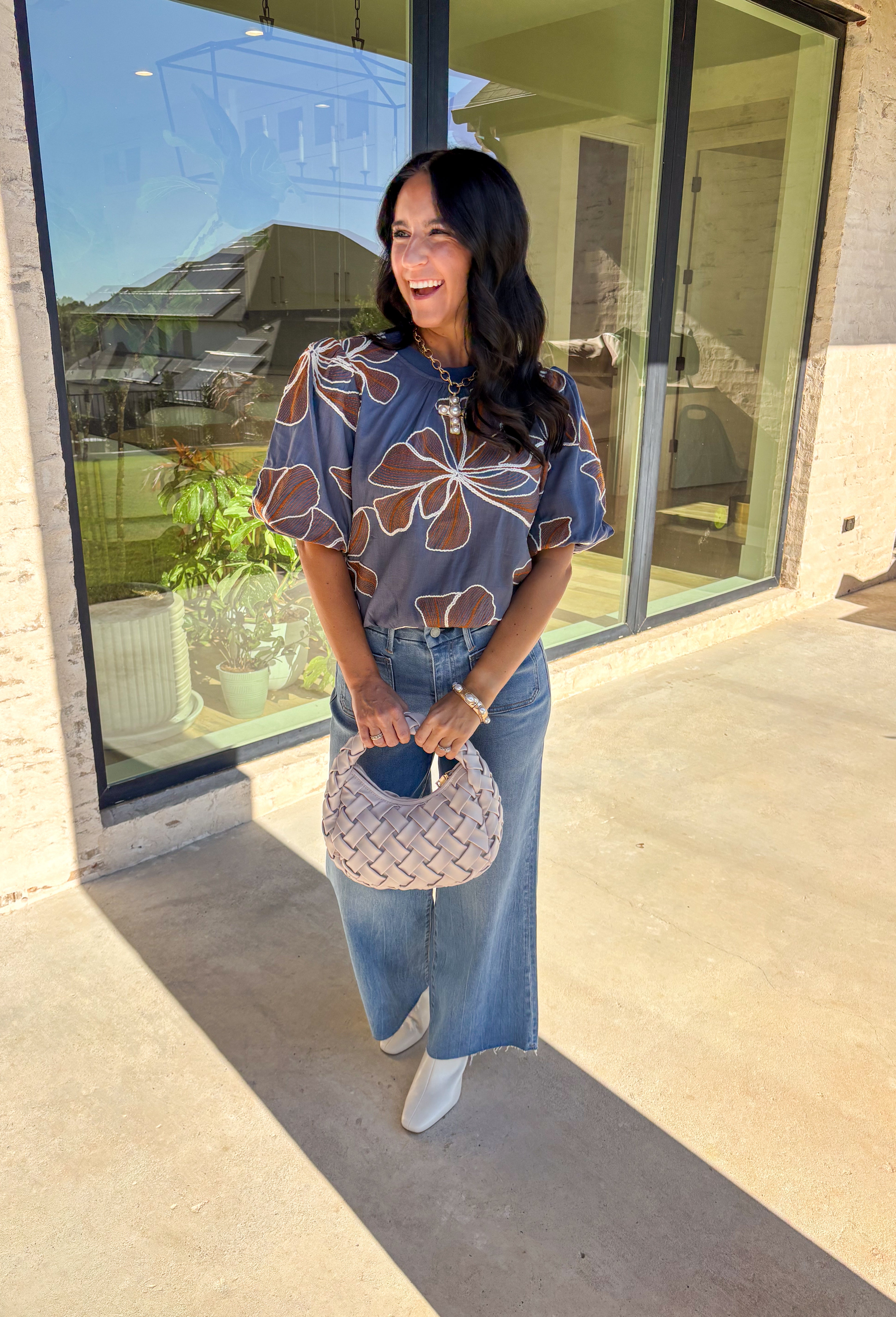 Effortlessly charming, this blue puff sleeve top by Voy is a fall favorite with a touch of whimsy. Designed with an oversized rust and white embroidered floral pattern throughout, it brings texture and color to your everyday look. The short puff sleeves and lettuce hem add a feminine finish, while the soft linen-blend fabric keeps it lightweight and breathable. Perfect for pairing with denim or skirts all season long.