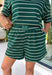 Easy, comfortable, and made for everyday wear, these hunter green striped shorts are a fall favorite you'll reach for again and again. Crafted from a soft knit fabric with an easy elastic waistband, they offer the perfect blend of comfort and style. The timeless white stripe print gives them a classic look, while the side pockets add everyday functionality. Pair them with the matching top for an effortlessly coordinated set