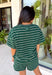 Comfort meets effortless style in this hunter green striped tee. Featuring a timeless white stripe print, this soft tee is the perfect piece to take you from laid-back weekends to busy weekdays with ease. Wear it with the matching shorts for a coordinated set that's equal parts cozy and stylish, or mix and match it with your favorite denim, or leggings, for endless outfit options. 