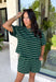 Comfort meets effortless style in this hunter green striped tee. Featuring a timeless white stripe print, this soft tee is the perfect piece to take you from laid-back weekends to busy weekdays with ease. Wear it with the matching shorts for a coordinated set that's equal parts cozy and stylish, or mix and match it with your favorite denim, or leggings, for endless outfit options. 
