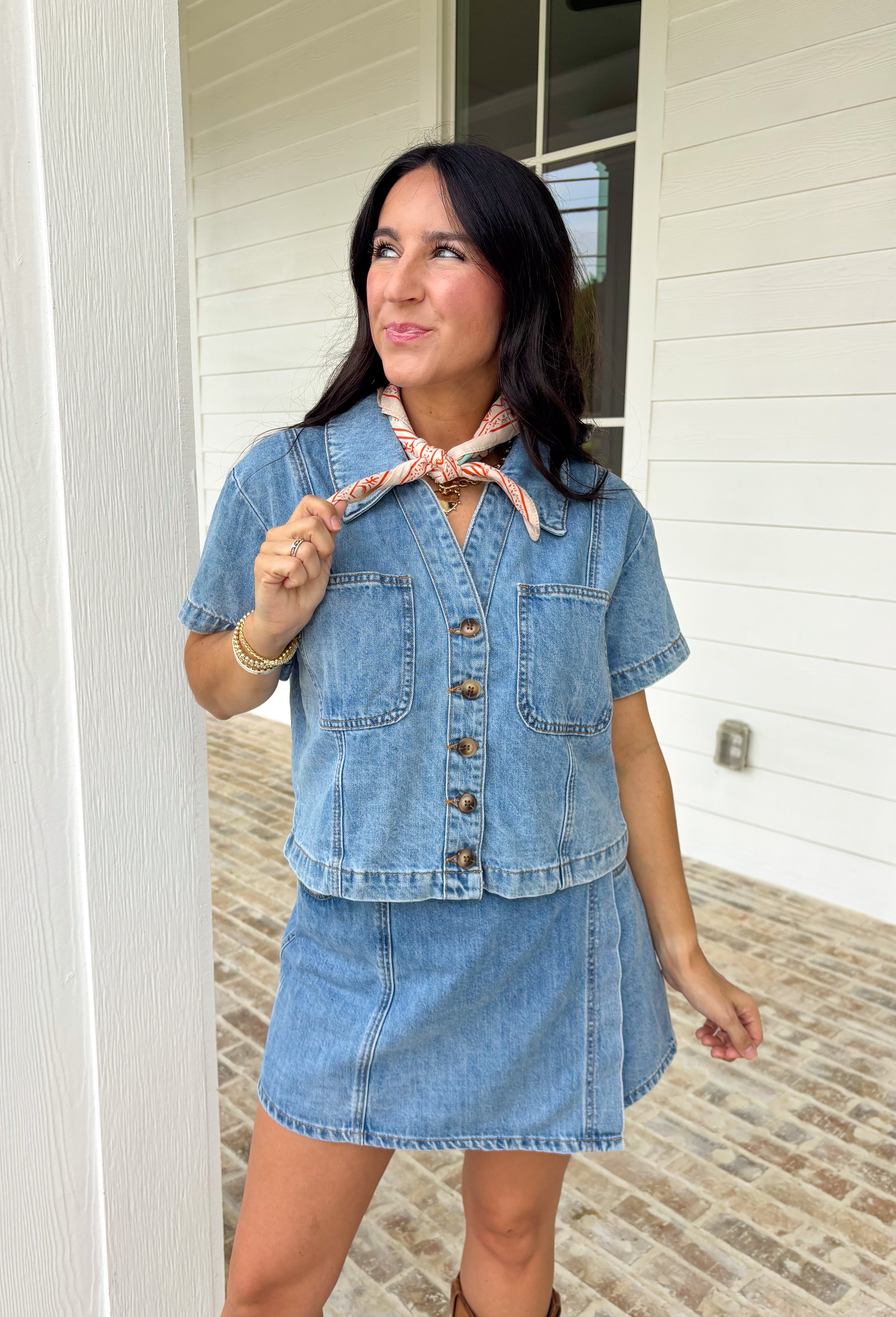 This medium wash button down denim top is one of those pieces you’ll keep reaching for all spring long! Made from 100% cotton, it’s lightweight, breathable, and perfect for layering or wearing on its own. The classic collared neckline and front pockets give it that timeless, easygoing feel, while the medium wash makes it endlessly versatile. Pair it with the matching skort for a matching set, or throw it on with white denim, skirts, —it’s the ultimate grab-and-go staple for busy days.