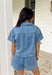This medium wash button down denim top is one of those pieces you’ll keep reaching for all spring long! Made from 100% cotton, it’s lightweight, breathable, and perfect for layering or wearing on its own. The classic collared neckline and front pockets give it that timeless, easygoing feel, while the medium wash makes it endlessly versatile. Pair it with the matching skort for a matching set, or throw it on with white denim, skirts, —it’s the ultimate grab-and-go staple for busy days.