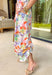 Say hello to your new one-and-done spring outfit! This white jumpsuit is covered in the prettiest colorful floral print with pops of green, orange, purple, pink, and yellow—basically sunshine in clothing form. The square neckline gives it a clean, flattering shape, while the smocked back keeps it comfy and flexible. Finished with side pockets (yes please), a side zipper for easy on-and-off, and adjustable ties at the waist and ankles, this piece is made for everything from weekend plans to vacation days.