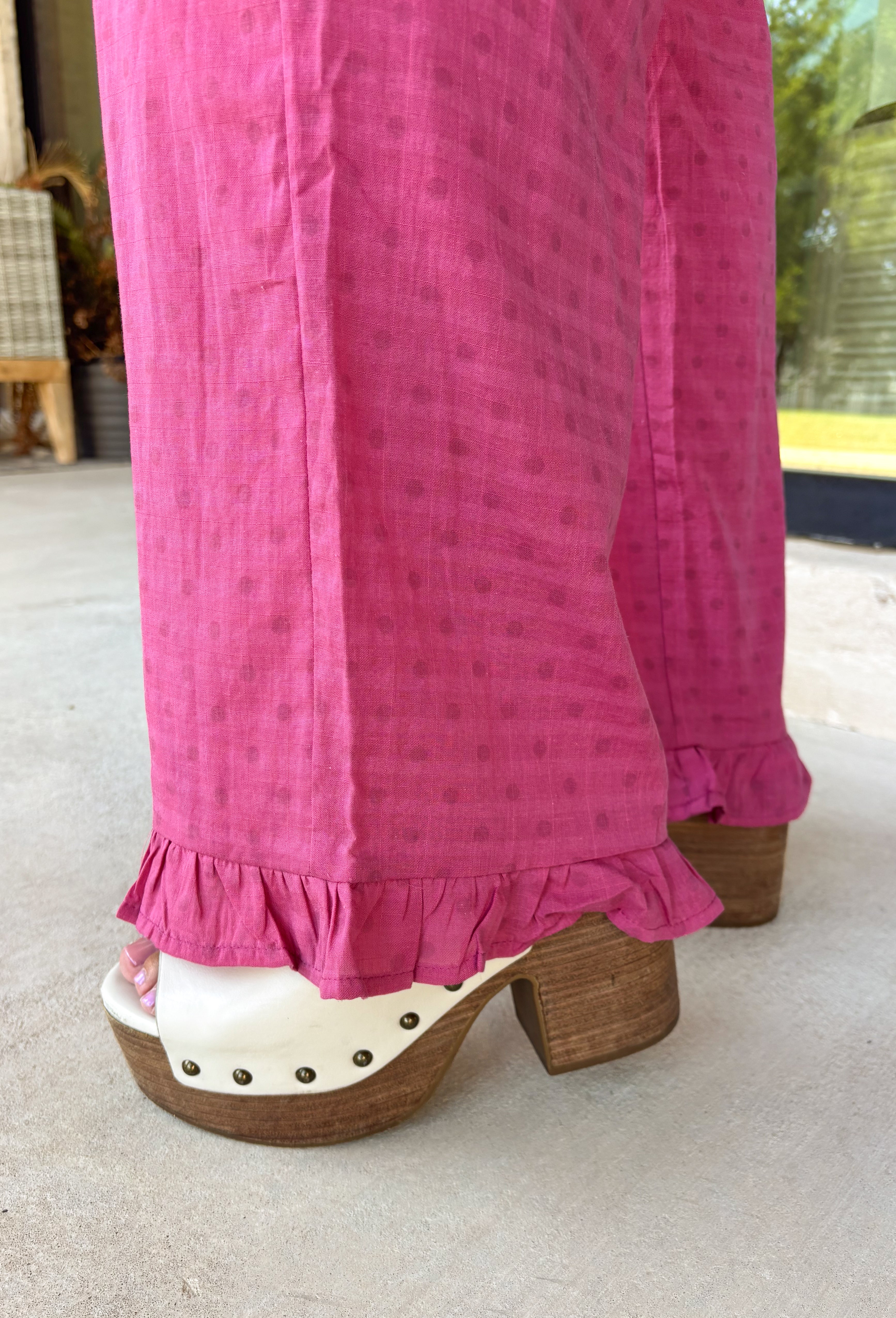A playful pink palette gives these pants from Twentifourth plenty of personality while still keeping them easy to style. The subtle monochromatic polka dot print adds a fun touch of texture without overpowering the look, while the ruffle hem gives the relaxed silhouette a sweet finishing detail. An elastic waistband with a drawstring keeps them comfortable for all-day wear, and side and back pockets add everyday function. 