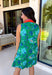 Fresh, vibrant, and made for sunny days, this sleeveless green dress is blooming with a beautiful blue floral print that instantly brightens your look. The pink and tomato red contrast trim along the collared neckline and along the front adds a playful pop of color that makes this piece feel extra special. It’s the kind of dress you’ll reach for when you want something easy, flattering, and full of personality.