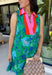 Fresh, vibrant, and made for sunny days, this sleeveless green dress is blooming with a beautiful blue floral print that instantly brightens your look. The pink and tomato red contrast trim along the collared neckline and along the front adds a playful pop of color that makes this piece feel extra special. It’s the kind of dress you’ll reach for when you want something easy, flattering, and full of personality.