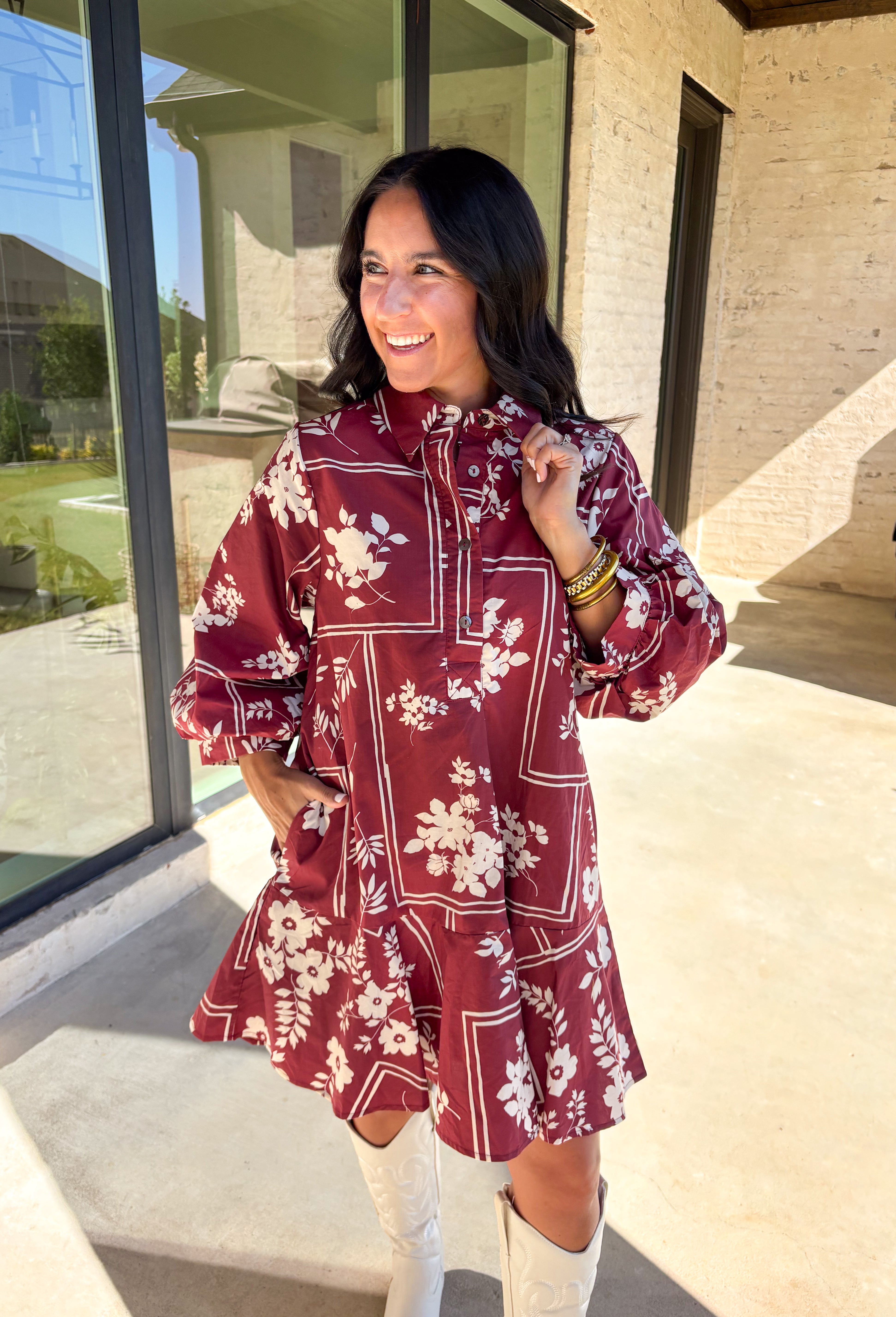 Effortless and feminine, this brick red dress is blooming with white botanical florals for a timeless autumn look. Featuring ¾ sleeves and a button-front closure, it blends comfort with charm. Side pockets add a touch of practicality, while the ruffle-free silhouette keeps it simple and chic. Fully lined and made from breathable cotton, this is the kind of dress you’ll love to style for everyday wear or seasonal gatherings.