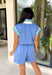This light blue romper is the ultimate mix of sporty and effortless for summer! Made from a buttery soft fabric, it’s designed for all-day comfort while still looking put together. The white and green stripe trim along the neckline and sleeves gives it that fun athletic vibe, while the quarter zip and collared neckline add a polished touch. With an elastic waist and side pockets, it’s as functional as it is cute.