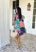 This light blue dress is bringing all the tropical energy in the prettiest way. Featuring a colorful abstract print with pops of green, navy, orange, and pink, it feels fresh, vibrant, and ready for sunshine. The square neckline adds a flattering, modern touch, while the elastic sleeves give it that soft, feminine shape we love. A smocked back ensures a comfortable, flexible fit, and the fully lined design keeps it easy to wear all day long. 