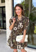 Warm autumn shades make this floral dress from Entro an easy pick for all your fall plans. The rich brown background is paired with a neutral floral print, creating a seasonal look that works beautifully for family photos, brunch, church, and weekend gatherings. A classic shirt collar and button-front closure give it a put-together feel, while short puff sleeves add just the right amount of shape. Pleated detailing at the back brings an unexpected touch to the silhouette.