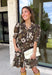 Warm autumn shades make this floral dress from Entro an easy pick for all your fall plans. The rich brown background is paired with a neutral floral print, creating a seasonal look that works beautifully for family photos, brunch, church, and weekend gatherings. A classic shirt collar and button-front closure give it a put-together feel, while short puff sleeves add just the right amount of shape. Pleated detailing at the back brings an unexpected touch to the silhouette.