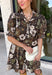 Warm autumn shades make this floral dress from Entro an easy pick for all your fall plans. The rich brown background is paired with a neutral floral print, creating a seasonal look that works beautifully for family photos, brunch, church, and weekend gatherings. A classic shirt collar and button-front closure give it a put-together feel, while short puff sleeves add just the right amount of shape. Pleated detailing at the back brings an unexpected touch to the silhouette.
