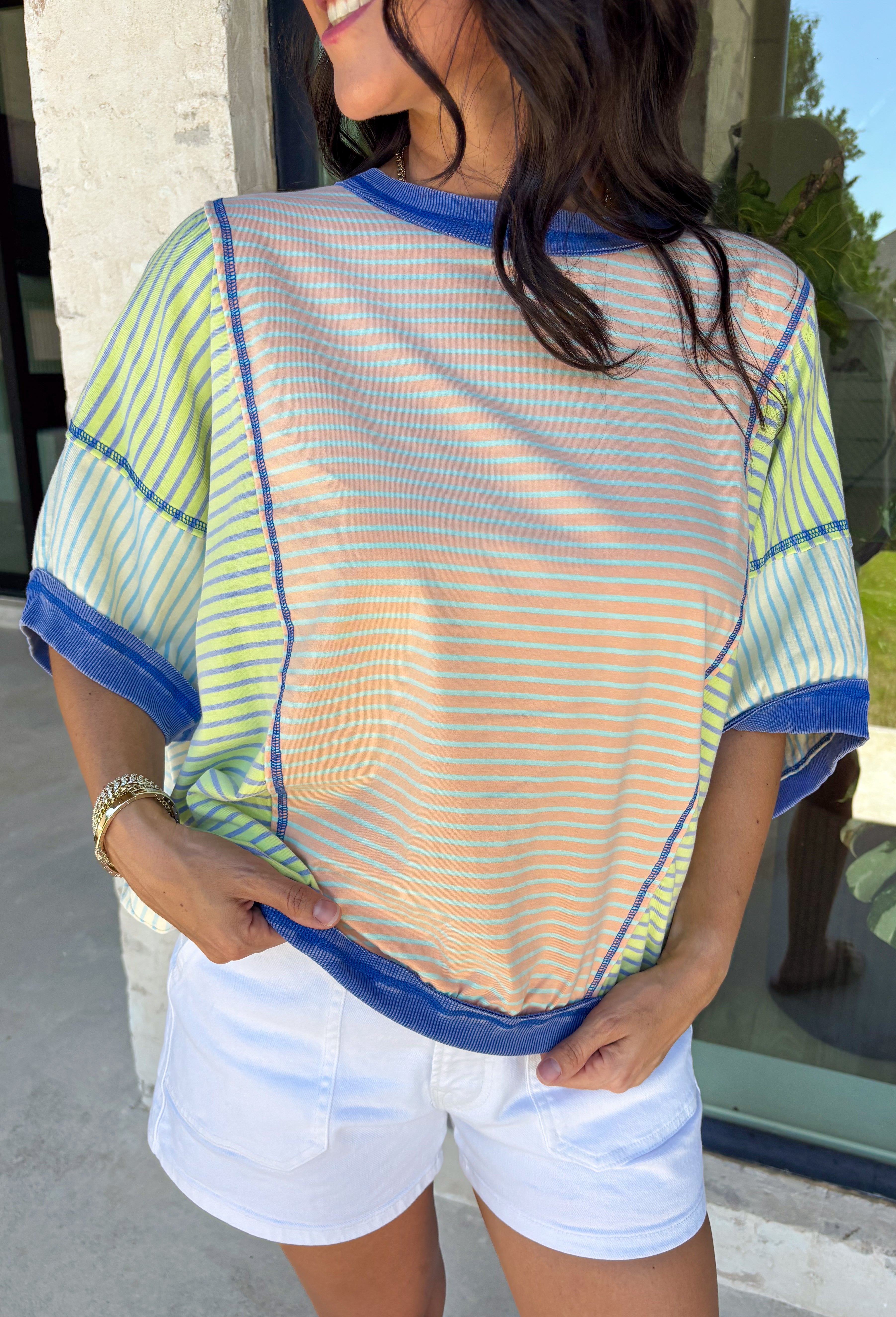 This color block stripe top is the perfect mix of laid-back and fun for summer! With shades of coral, tan, green, and blue, it brings a fresh pop of color while still feeling easy to style. The dark blue threading throughout adds a subtle contrast that pulls everything together, and the dolman sleeves give it that relaxed, effortless fit. Soft, stretchy, and breathable, it’s perfect for busy days when you want to feel comfortable but still put together. 