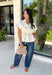 A timeless neutral top is one of the best investments for your fall wardrobe! This off white cotton blouse combines classic details with a flattering silhouette you'll love wearing on repeat. The collared neckline and button front create a polished look, while the elastic drawstring waist cinches just right for a feminine shape. Finished with a peplum hem and cap sleeves, it's the perfect blend of comfortable and elevated. 