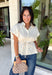 A timeless neutral top is one of the best investments for your fall wardrobe! This off white cotton blouse combines classic details with a flattering silhouette you'll love wearing on repeat. The collared neckline and button front create a polished look, while the elastic drawstring waist cinches just right for a feminine shape. Finished with a peplum hem and cap sleeves, it's the perfect blend of comfortable and elevated. 