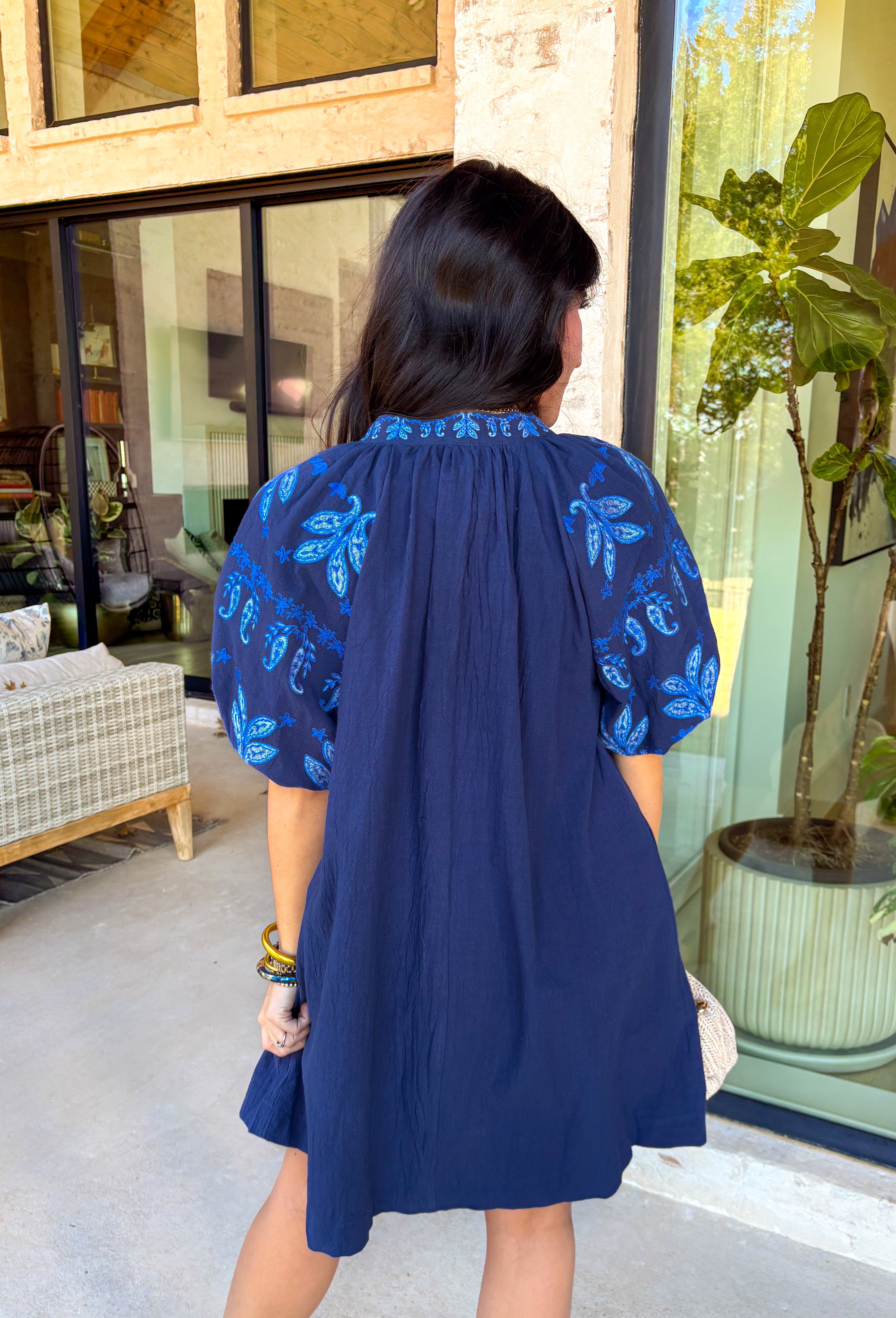 This short sleeve navy dress is such a pretty, easy pick for spring days when you want something simple but still special! The shades of blue embroidery along the neckline and sleeves add the perfect pop of detail, giving it a fresh, elevated look without feeling too dressy. Puff sleeves bring a feminine touch, while the relaxed fit keeps it comfortable enough for all-day wear.