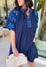 This short sleeve navy dress is such a pretty, easy pick for spring days when you want something simple but still special! The shades of blue embroidery along the neckline and sleeves add the perfect pop of detail, giving it a fresh, elevated look without feeling too dressy. Puff sleeves bring a feminine touch, while the relaxed fit keeps it comfortable enough for all-day wear.