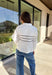A polished essential with a playful twist—this white long sleeve top is designed with bold black scalloped trim running across the front and around the back for eye-catching contrast. The collared neckline and button detail give it a timeless look, while the crisp cotton fabric keeps it breathable and easy to wear. Perfect for layering or styling solo, this top transitions effortlessly from office days to cozy outings.