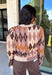 Classic patterns never go out of style, and this beautiful cardigan from THML is the perfect example. Designed with a timeless tan and brown argyle pattern, this cozy knit is finished with elegant gold buttons that add a polished touch. The neutral color palette makes it effortless to pair with everything in your wardrobe, while the ribbed neckline, cuffs, and hem create a refined finish. 