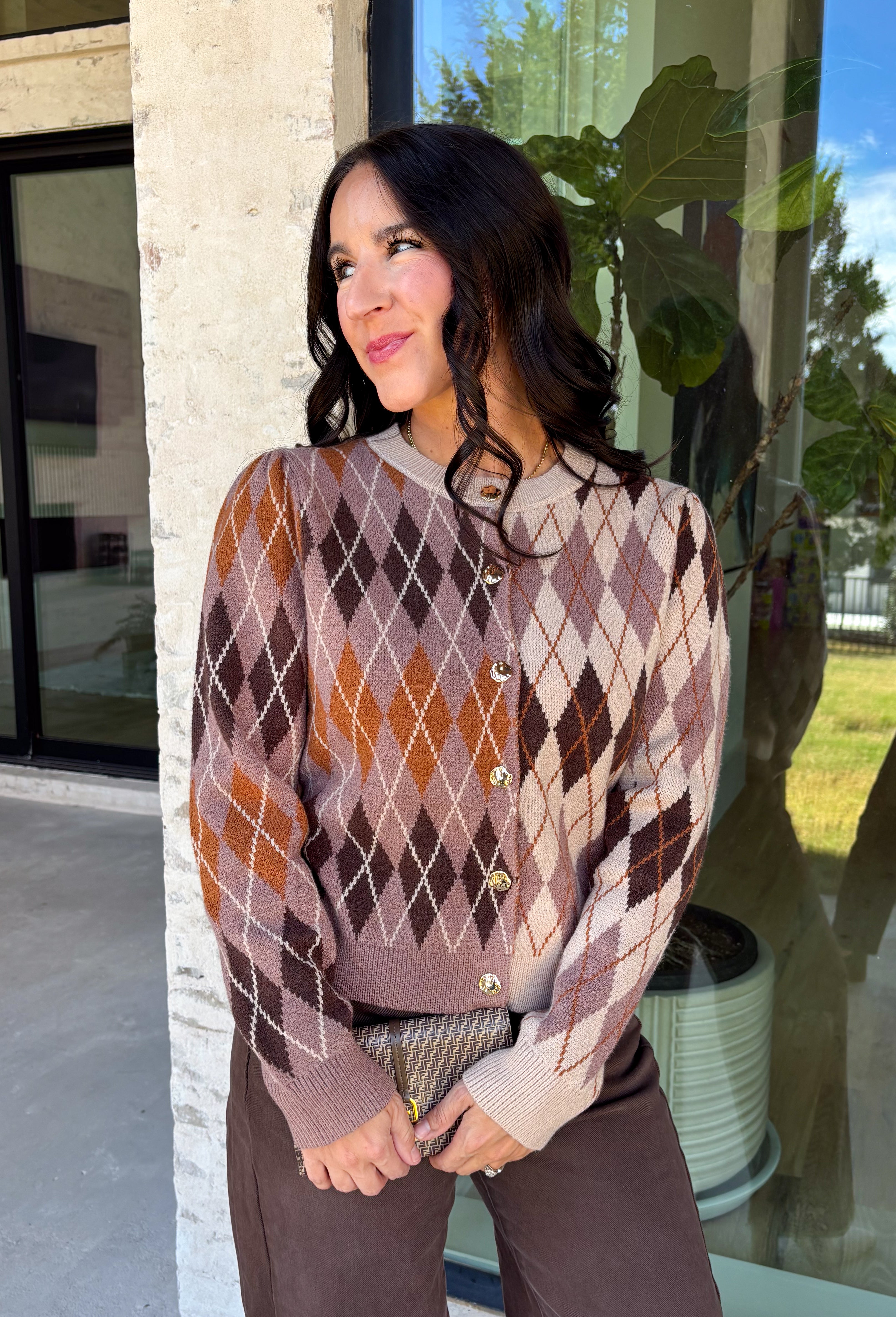 Classic patterns never go out of style, and this beautiful cardigan from THML is the perfect example. Designed with a timeless tan and brown argyle pattern, this cozy knit is finished with elegant gold buttons that add a polished touch. The neutral color palette makes it effortless to pair with everything in your wardrobe, while the ribbed neckline, cuffs, and hem create a refined finish. 
