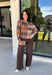 Classic patterns never go out of style, and this beautiful cardigan from THML is the perfect example. Designed with a timeless tan and brown argyle pattern, this cozy knit is finished with elegant gold buttons that add a polished touch. The neutral color palette makes it effortless to pair with everything in your wardrobe, while the ribbed neckline, cuffs, and hem create a refined finish. 