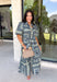 Bring effortless elegance to your wardrobe with this beautifully detailed dress from Entro. Designed with a soft light blue backdrop and an eye-catching abstract print in shades of navy, white, and cream, this timeless piece is perfect for everything from brunch dates to special gatherings. A subtle ruffle neckline adds a feminine touch, while the black buttons outlined in gold create an elevated, polished finish. 