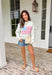 This heather grey pullover is the perfect cozy-meets-festive piece for your summer celebrations! Featuring red and white stripes with a blue and white gingham flag, it brings a fun, playful take on classic patriotic style. The mock neck adds a slightly elevated feel, while the soft cotton fabric keeps it comfortable for those breezy summer nights—think fireworks, lake evenings, or early morning coffee runs. It’s an easy throw-on piece that still feels festive and put together. 
