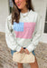 This heather grey pullover is the perfect cozy-meets-festive piece for your summer celebrations! Featuring red and white stripes with a blue and white gingham flag, it brings a fun, playful take on classic patriotic style. The mock neck adds a slightly elevated feel, while the soft cotton fabric keeps it comfortable for those breezy summer nights—think fireworks, lake evenings, or early morning coffee runs. It’s an easy throw-on piece that still feels festive and put together. 