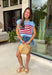 This light blue sweater top is the perfect way to celebrate summer in style! Featuring an American flag design on the front, it brings all the patriotic charm while still feeling classic and easy to wear. The lightweight knit construction makes it ideal for warm-weather celebrations, and the cap sleeves add a flattering, feminine touch. Whether you're heading to a backyard BBQ, a parade, a lake weekend, or fireworks with friends, this top is ready for all your 4th of July festivities. 