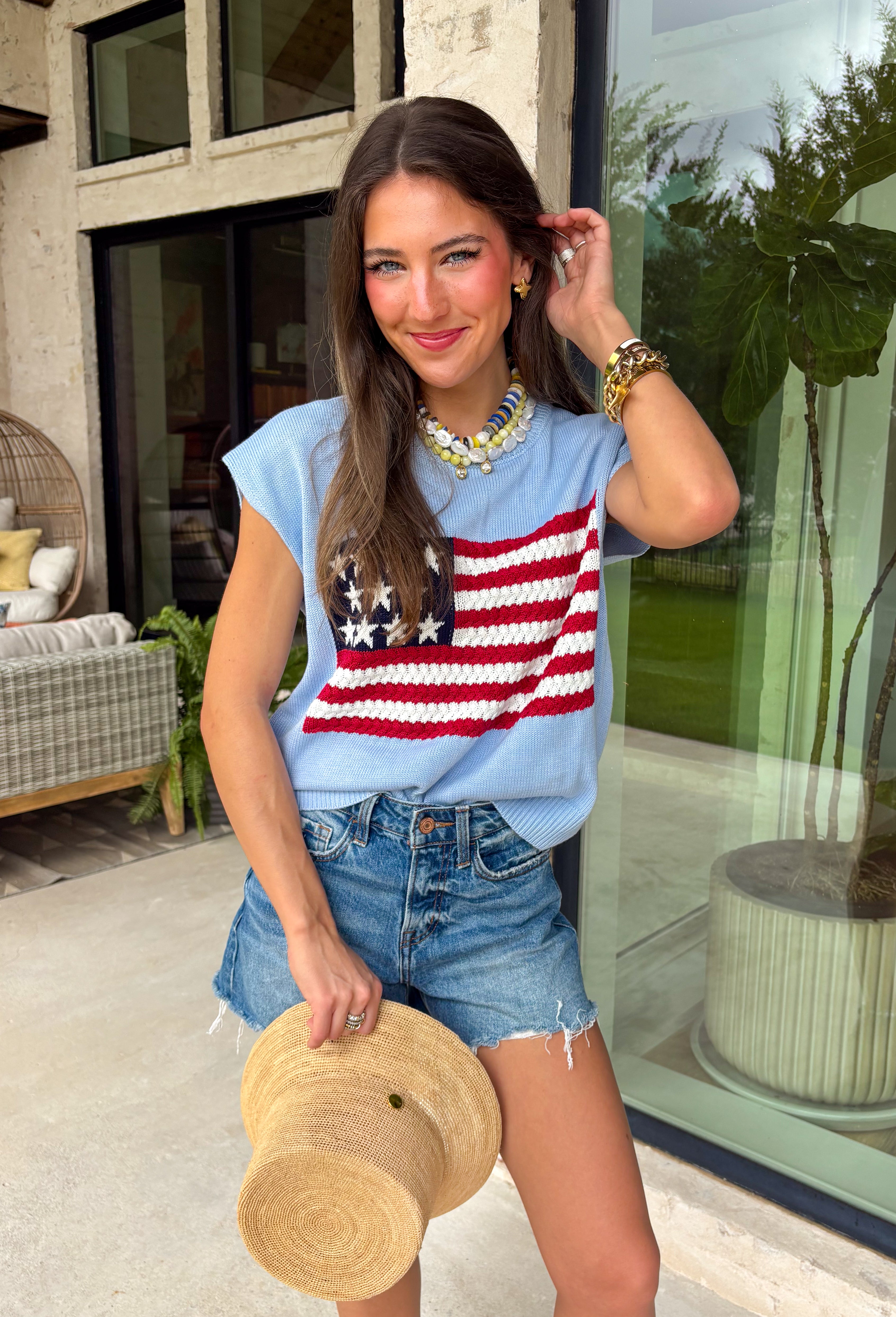 This light blue sweater top is the perfect way to celebrate summer in style! Featuring an American flag design on the front, it brings all the patriotic charm while still feeling classic and easy to wear. The lightweight knit construction makes it ideal for warm-weather celebrations, and the cap sleeves add a flattering, feminine touch. Whether you're heading to a backyard BBQ, a parade, a lake weekend, or fireworks with friends, this top is ready for all your 4th of July festivities. 