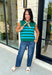 Classic stripes get a bold fall refresh with this cozy sleeveless sweater! Featuring a rich pine green knit with vibrant blue stripes, this sleeveless top is an easy way to add color to your seasonal wardrobe. Functional gold button closures along the sides add a unique, elevated touch, while the ribbed crew neckline and hem give it a timeless finish.