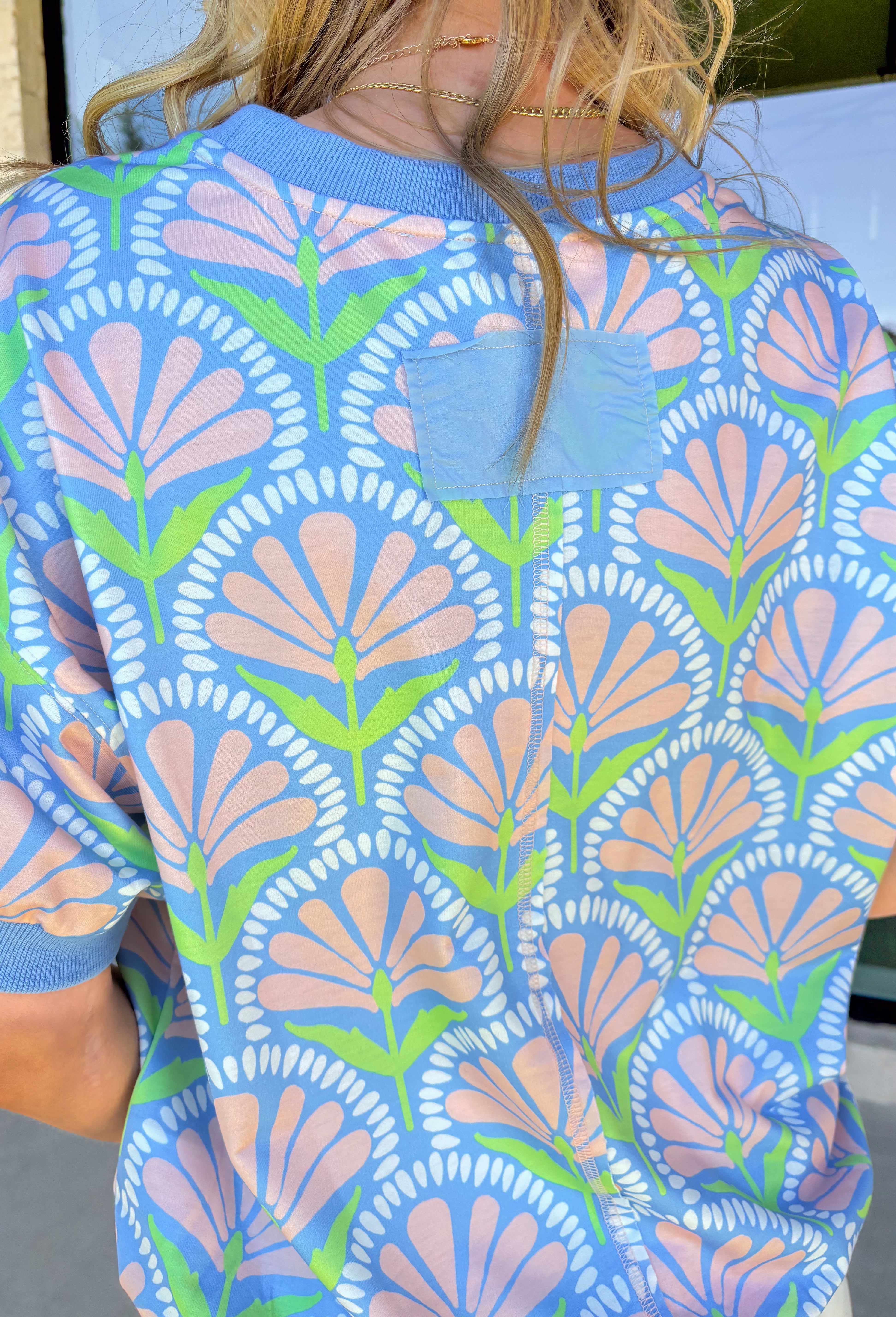 This short sleeve light blue top by Umgee is such a sweet and easy way to bring a little spring color into your everyday look. The floral print features soft pops of peach, white, and green for a fresh, pretty vibe that pairs perfectly with denim, white jeans, or even shorts once the weather warms up.The fabric has a light stretch that makes it easy to move in and super comfortable for all-day wear—whether you’re heading to work, running errands, or meeting friends for lunch. 