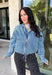 A classic denim layer gets a fresh update with this medium wash jacket from Risen. The timeless wash makes it easy to throw on with everything from fall dresses to cozy knits, while the front zipper closure gives it a more modern feel than your traditional button-front denim jacket. A collared neckline keeps the look classic, and button cuffs add a familiar denim detail at the sleeves. The adjustable toggle drawstring hem lets you customize the shape, while side pockets add everyday function.
