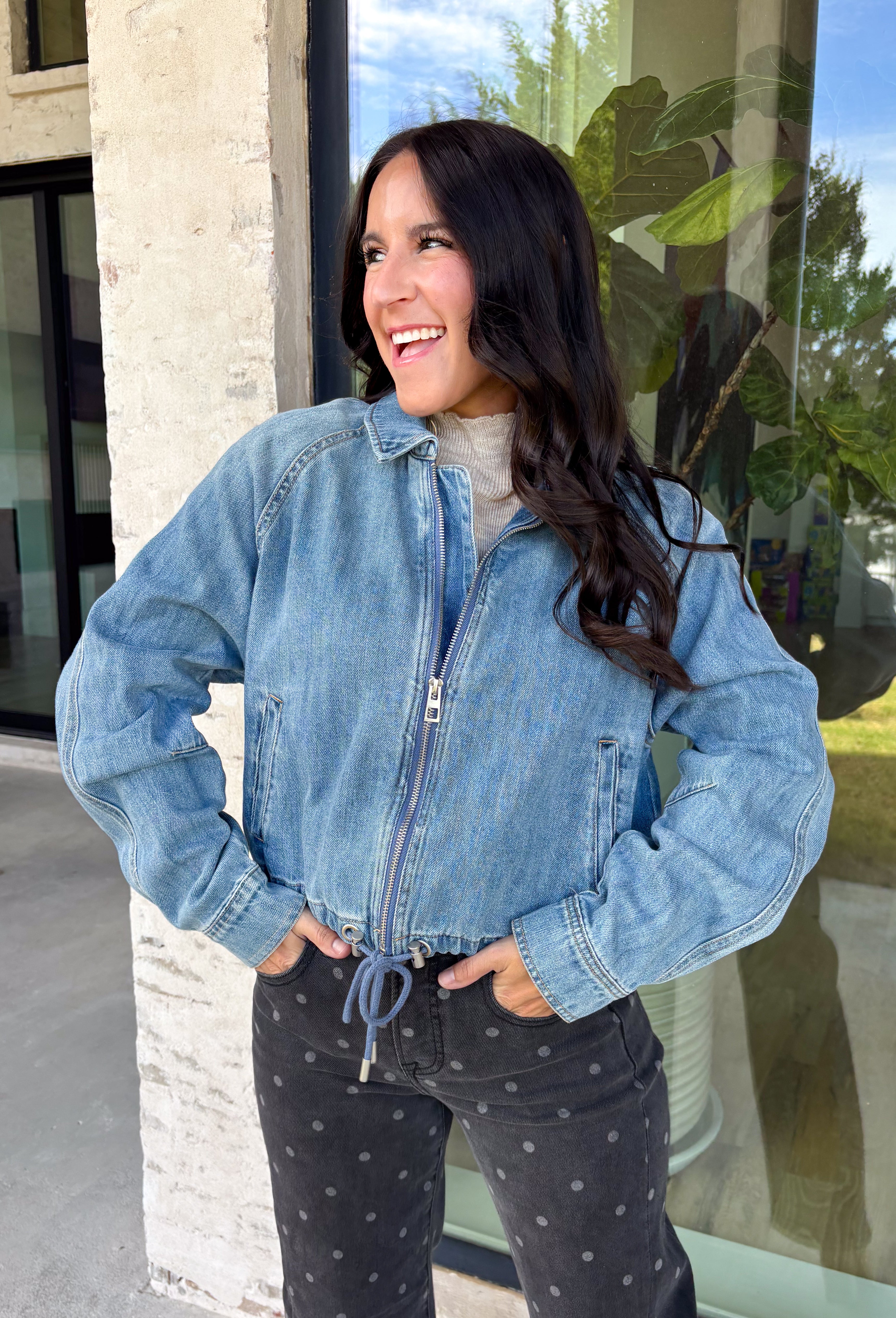 A classic denim layer gets a fresh update with this medium wash jacket from Risen. The timeless wash makes it easy to throw on with everything from fall dresses to cozy knits, while the front zipper closure gives it a more modern feel than your traditional button-front denim jacket. A collared neckline keeps the look classic, and button cuffs add a familiar denim detail at the sleeves. The adjustable toggle drawstring hem lets you customize the shape, while side pockets add everyday function.