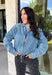 A classic denim layer gets a fresh update with this medium wash jacket from Risen. The timeless wash makes it easy to throw on with everything from fall dresses to cozy knits, while the front zipper closure gives it a more modern feel than your traditional button-front denim jacket. A collared neckline keeps the look classic, and button cuffs add a familiar denim detail at the sleeves. The adjustable toggle drawstring hem lets you customize the shape, while side pockets add everyday function.