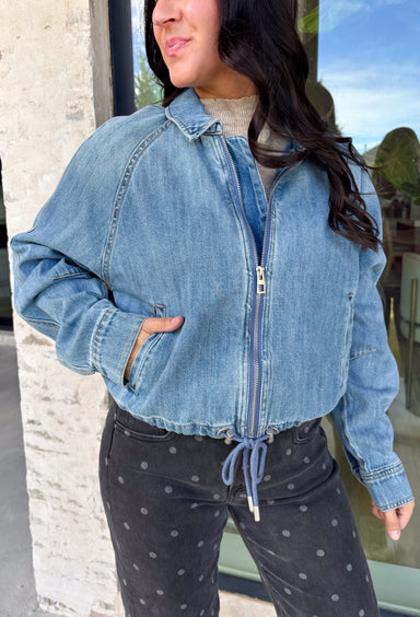 A classic denim layer gets a fresh update with this medium wash jacket from Risen. The timeless wash makes it easy to throw on with everything from fall dresses to cozy knits, while the front zipper closure gives it a more modern feel than your traditional button-front denim jacket. A collared neckline keeps the look classic, and button cuffs add a familiar denim detail at the sleeves. The adjustable toggle drawstring hem lets you customize the shape, while side pockets add everyday function.