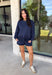 Cozy gets a pretty little upgrade with this navy sweatshirt from Sunday Edition. The classic long sleeve silhouette is finished with a lace hem, adding a feminine touch to an otherwise casual favorite. A soft fleece lining keeps it extra comfortable as chilly fall days start turning into winter weather. Pair it with the matching shorts for a cute coordinated set that’s perfect for relaxing, traveling, or casual weekend plans, or mix it into your closet with denim for an easy everyday outfit. 