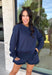 Cozy gets a pretty little upgrade with this navy sweatshirt from Sunday Edition. The classic long sleeve silhouette is finished with a lace hem, adding a feminine touch to an otherwise casual favorite. A soft fleece lining keeps it extra comfortable as chilly fall days start turning into winter weather. Pair it with the matching shorts for a cute coordinated set that’s perfect for relaxing, traveling, or casual weekend plans, or mix it into your closet with denim for an easy everyday outfit. 
