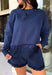Cozy gets a pretty little upgrade with this navy sweatshirt from Sunday Edition. The classic long sleeve silhouette is finished with a lace hem, adding a feminine touch to an otherwise casual favorite. A soft fleece lining keeps it extra comfortable as chilly fall days start turning into winter weather. Pair it with the matching shorts for a cute coordinated set that’s perfect for relaxing, traveling, or casual weekend plans, or mix it into your closet with denim for an easy everyday outfit. 
