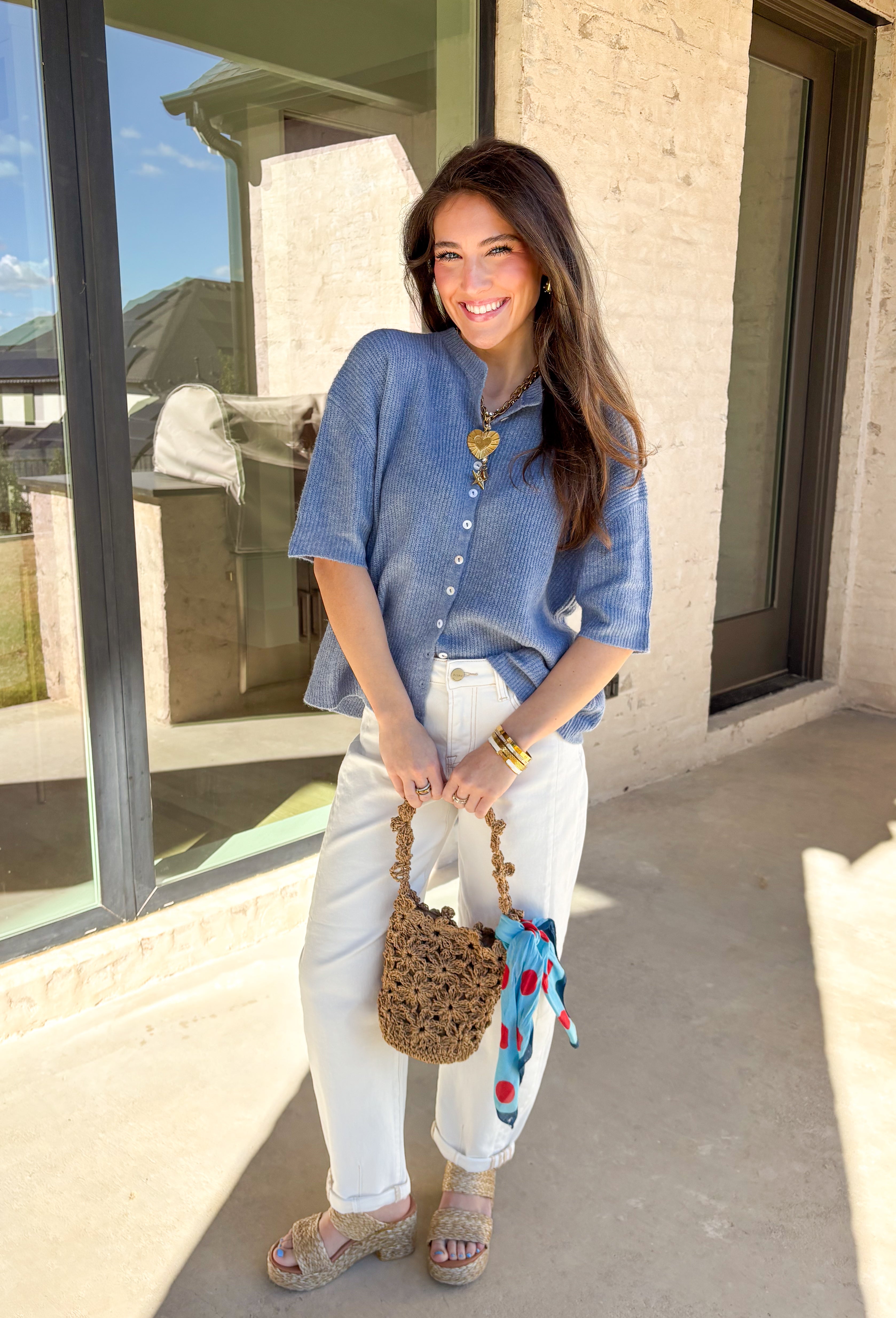 Soft, sweet, and perfect for spring layering, this light blue ribbed button-down knit short sleeve sweater by Things Between is an easy everyday favorite. The ribbed texture gives it a flattering fit, while the button-down front adds a classic touch you can wear closed as a top or slightly open over a tank for a more relaxed vibe. Lightweight with a cozy feel, this piece is perfect for those breezy spring mornings and cool evenings when you still want something cute and comfortable.