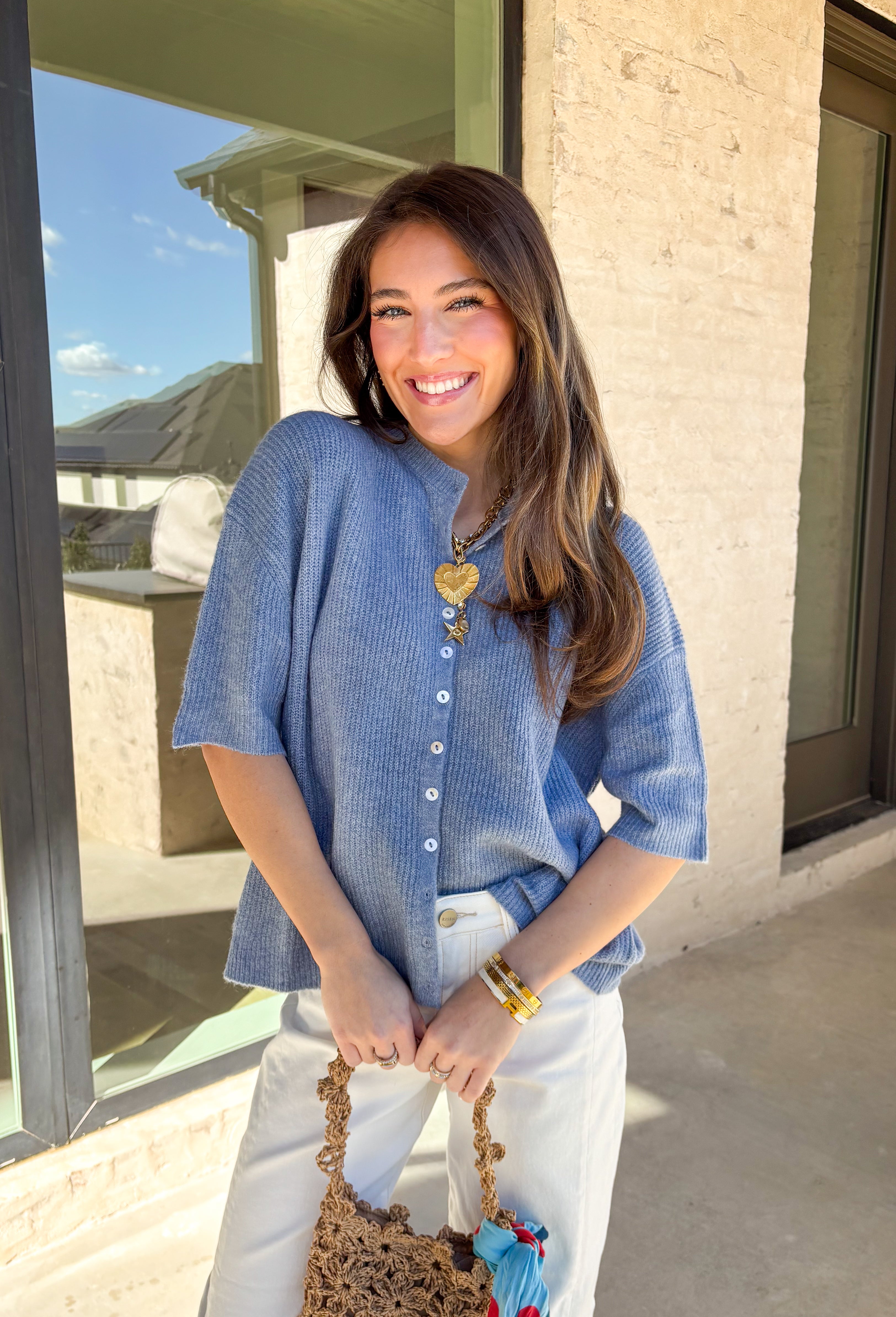 Soft, sweet, and perfect for spring layering, this light blue ribbed button-down knit short sleeve sweater by Things Between is an easy everyday favorite. The ribbed texture gives it a flattering fit, while the button-down front adds a classic touch you can wear closed as a top or slightly open over a tank for a more relaxed vibe. Lightweight with a cozy feel, this piece is perfect for those breezy spring mornings and cool evenings when you still want something cute and comfortable.