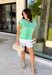 This green short sleeve top is the kind of easy, go-to piece you’ll reach for all summer long! The smocking detail across the front adds just the right amount of texture while creating a flattering, comfortable fit. Made from breathable 100% cotton, it’s lightweight and perfect for staying cool on warm days. It’s simple, versatile, and effortlessly put together—exactly what you want for busy days on the go. Pair it with denim shorts, white jeans, or a skirt for an easy everyday look. 
