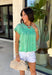 This green short sleeve top is the kind of easy, go-to piece you’ll reach for all summer long! The smocking detail across the front adds just the right amount of texture while creating a flattering, comfortable fit. Made from breathable 100% cotton, it’s lightweight and perfect for staying cool on warm days. It’s simple, versatile, and effortlessly put together—exactly what you want for busy days on the go. Pair it with denim shorts, white jeans, or a skirt for an easy everyday look. 