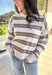 This neutral striped sweater by Double Zero brings effortless comfort and style to your fall wardrobe. Featuring a flecked knit texture with brown stripes throughout, this mock neck pullover is as cozy as it is chic. The soft, medium-weight knit makes it perfect for layering or wearing solo on those crisp autumn days.