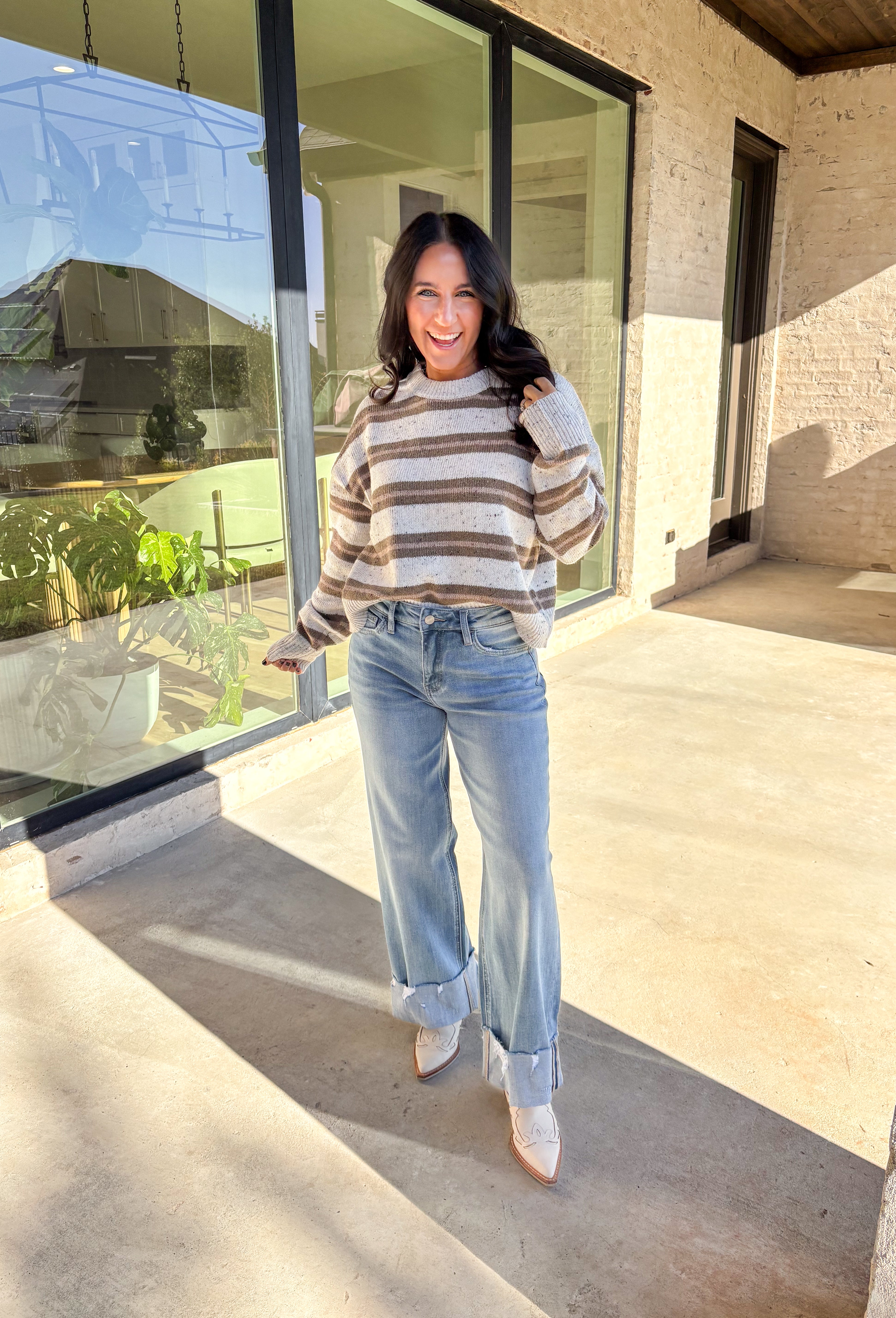 This neutral striped sweater by Double Zero brings effortless comfort and style to your fall wardrobe. Featuring a flecked knit texture with brown stripes throughout, this mock neck pullover is as cozy as it is chic. The soft, medium-weight knit makes it perfect for layering or wearing solo on those crisp autumn days.
