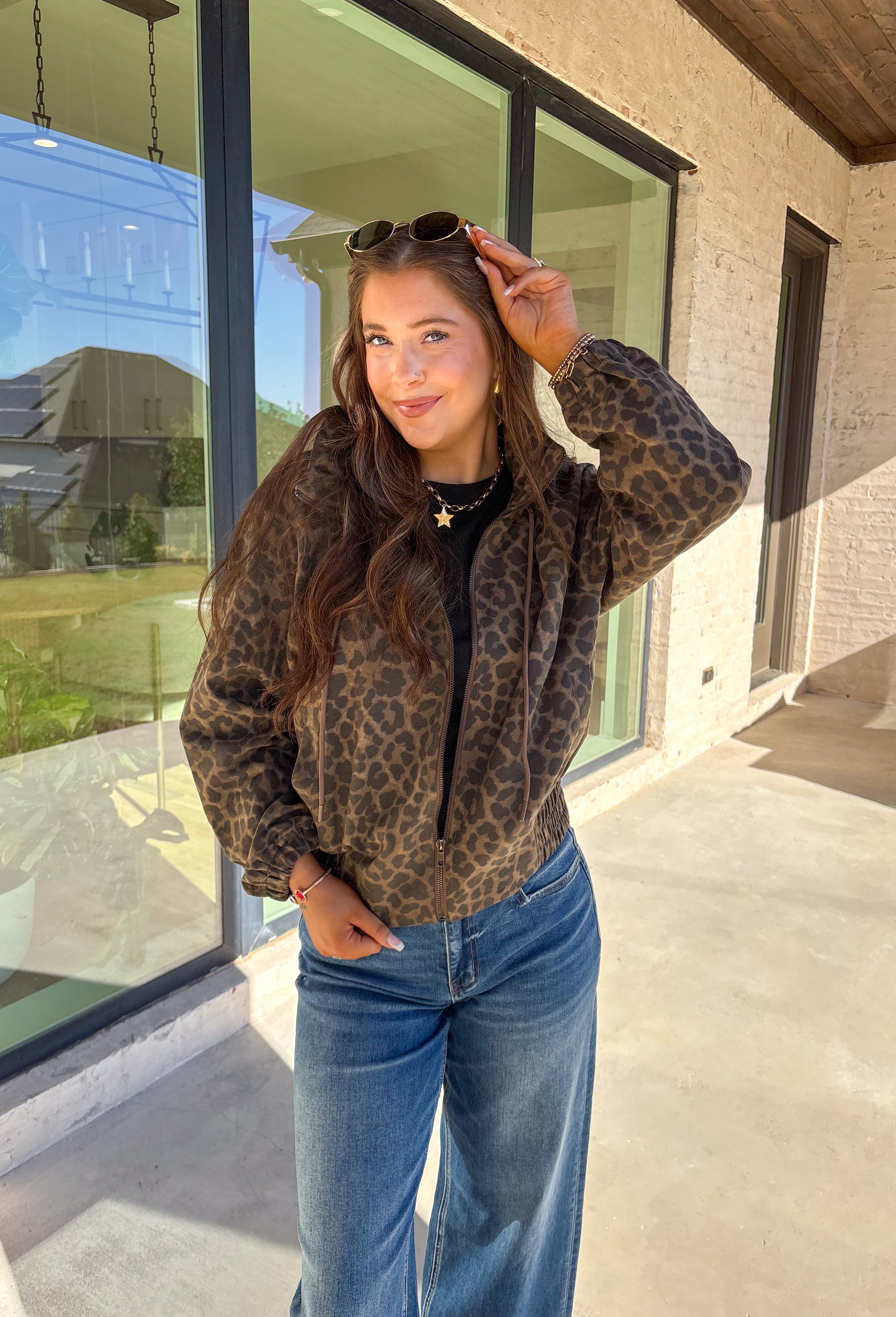 Bring the wild side to your fall layering with this leopard zip-up jacket! The ruffle neckline and tie-front detail add a playful twist to a classic print, while the elastic cuffs and hem keep it comfy and flattering. Toss it over your favorite tee and jeans for an effortless outfit that still makes a statement.
