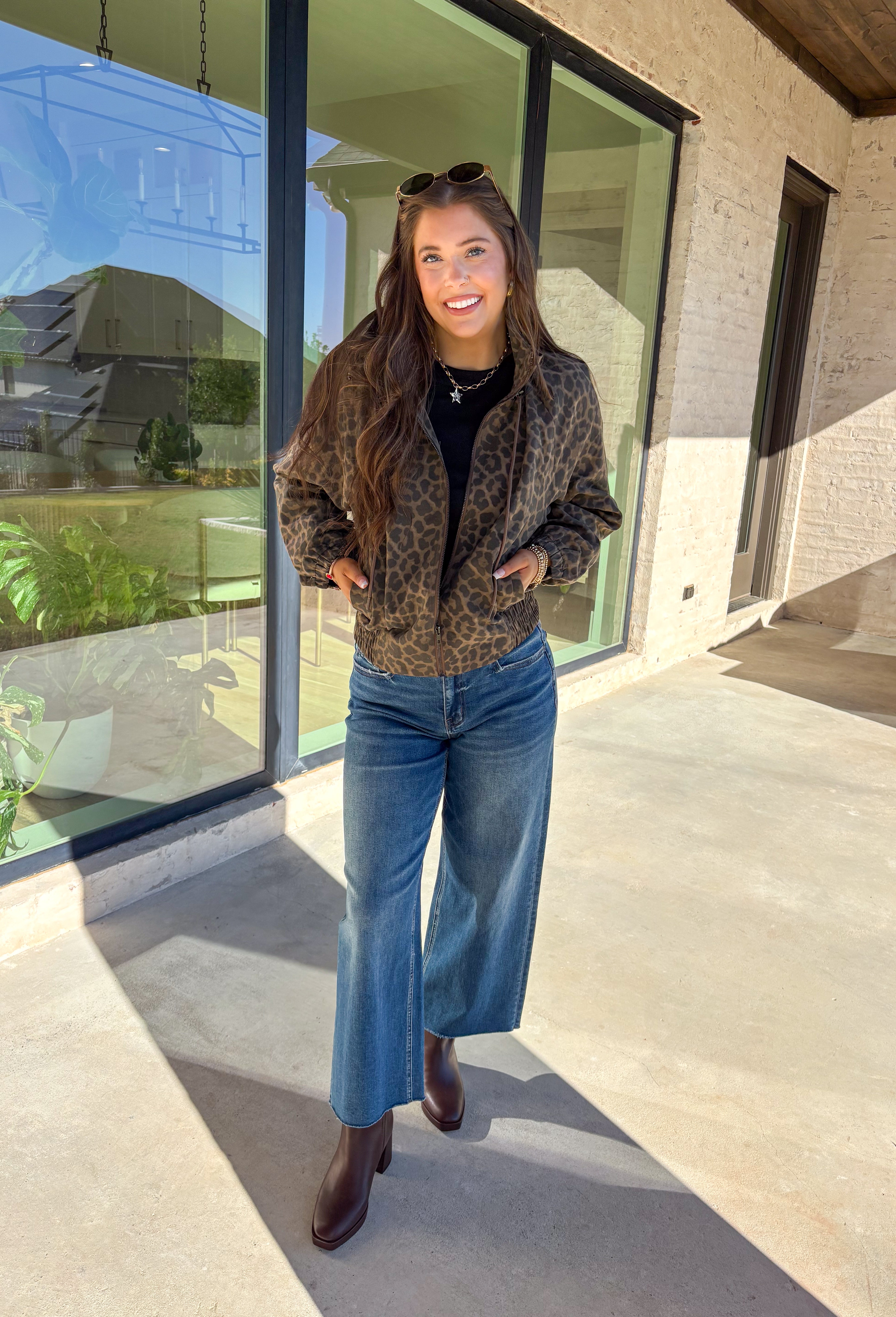Bring the wild side to your fall layering with this leopard zip-up jacket! The ruffle neckline and tie-front detail add a playful twist to a classic print, while the elastic cuffs and hem keep it comfy and flattering. Toss it over your favorite tee and jeans for an effortless outfit that still makes a statement.