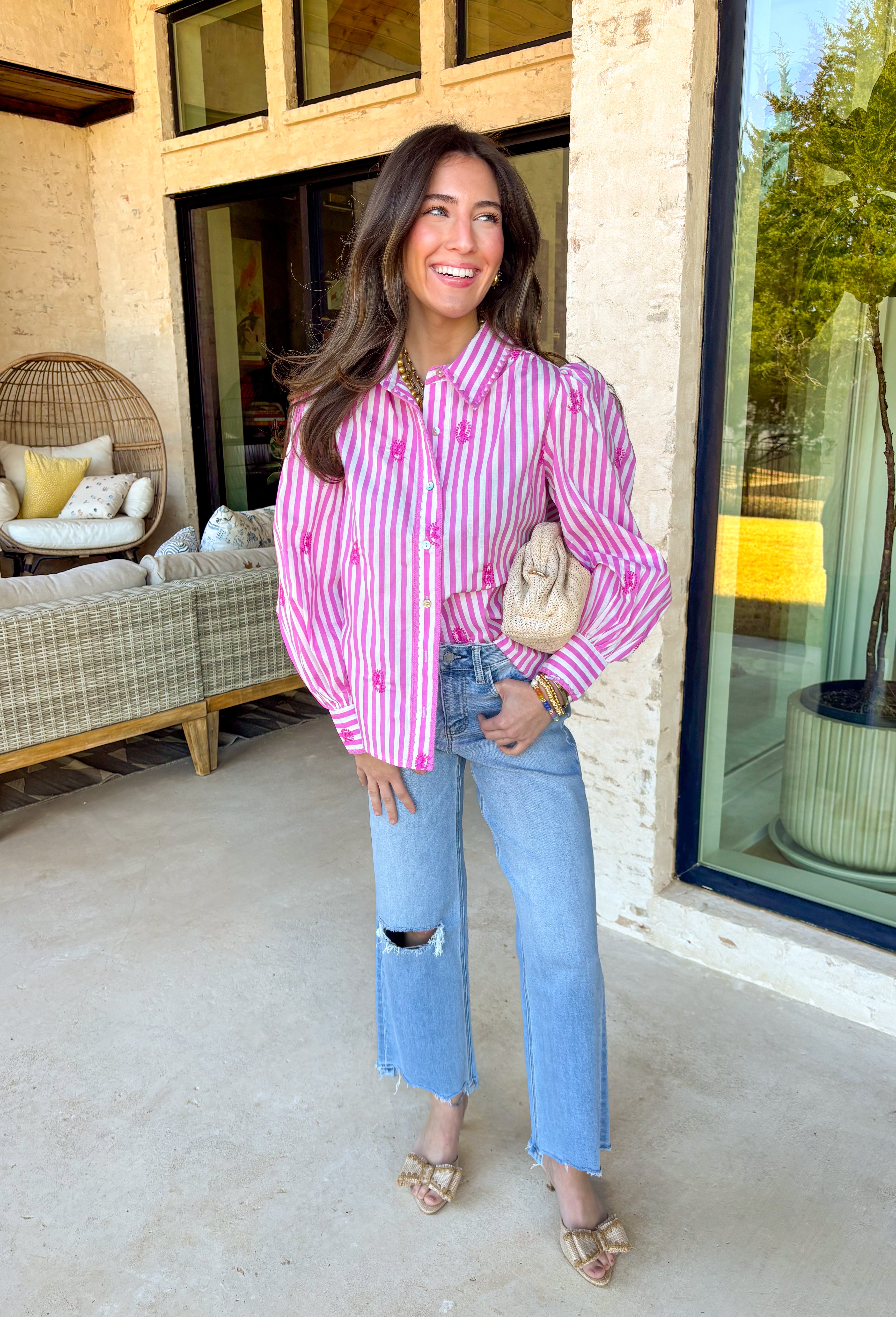 This pink and white striped button down is giving total springtime charm! With delicate embroidered pink paisley details sprinkled throughout, it’s the kind of top that feels classic at first glance… then you notice the pretty texture and it’s instantly a favorite. The collared neckline keeps it polished and easy to style, whether you’re heading to brunch, the office, or just want to look put-together for everyday plans. Lightweight and breathable, it’s a dreamy warm-weather staple you’ll reach for again an