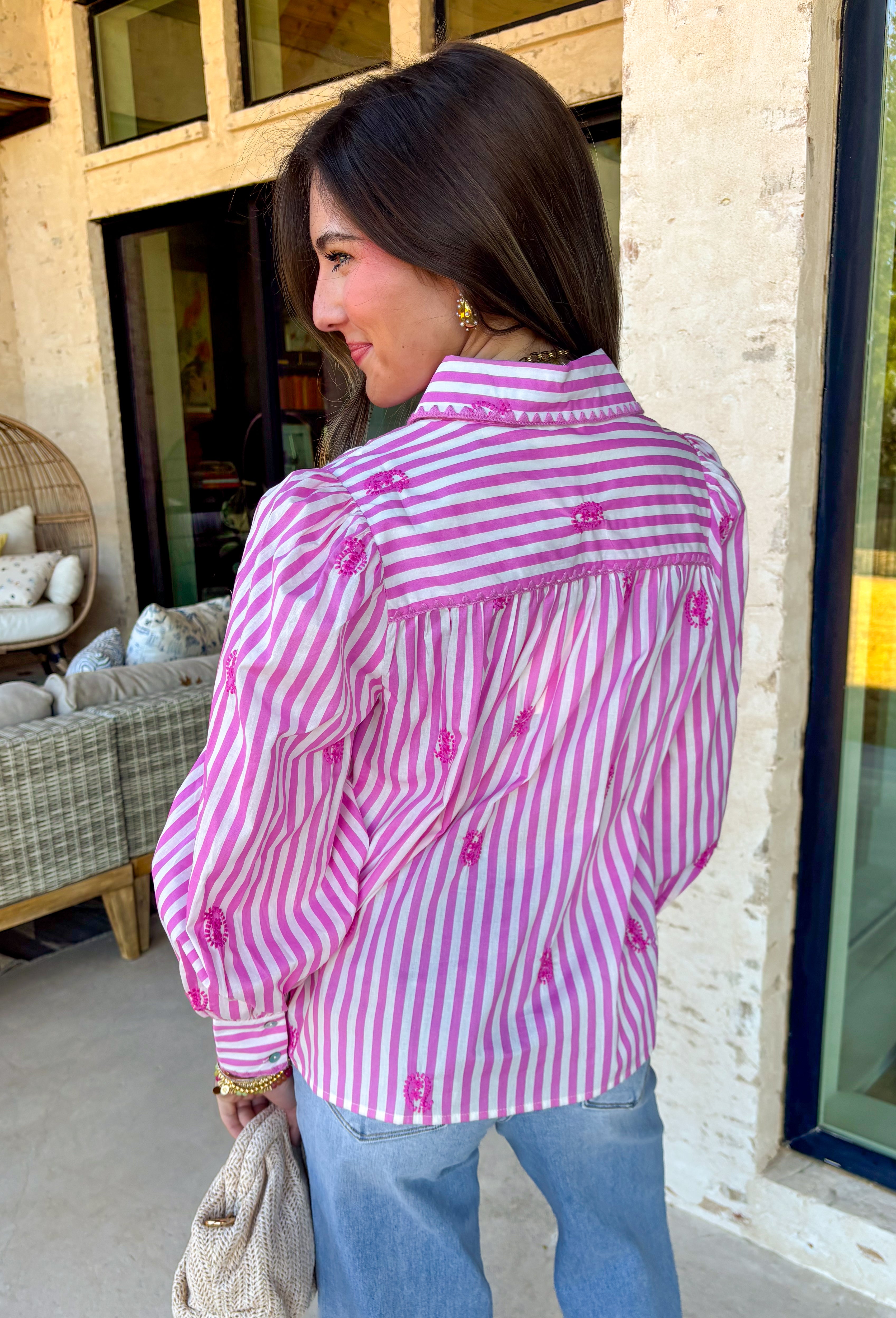 This pink and white striped button down is giving total springtime charm! With delicate embroidered pink paisley details sprinkled throughout, it’s the kind of top that feels classic at first glance… then you notice the pretty texture and it’s instantly a favorite. The collared neckline keeps it polished and easy to style, whether you’re heading to brunch, the office, or just want to look put-together for everyday plans. Lightweight and breathable, it’s a dreamy warm-weather staple you’ll reach for again an